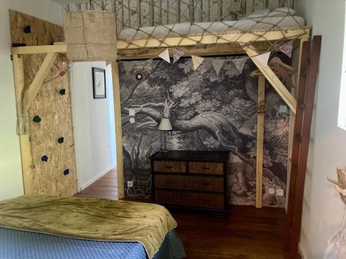 a bedroom with two bunk beds and a mural at L Henri in Oloron-Sainte-Marie
