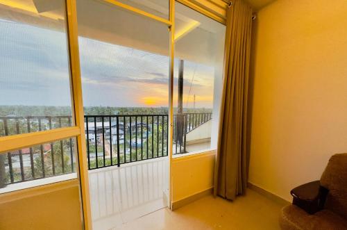 a room with a balcony with a view at Veu Ragamalika Apartment with Fully Equipped Kitchen, Balcony & Caretaker in Cochin