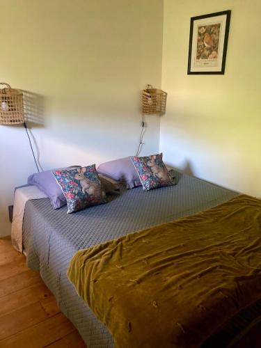 a bedroom with a bed with two pillows on it at L Henri in Oloron-Sainte-Marie