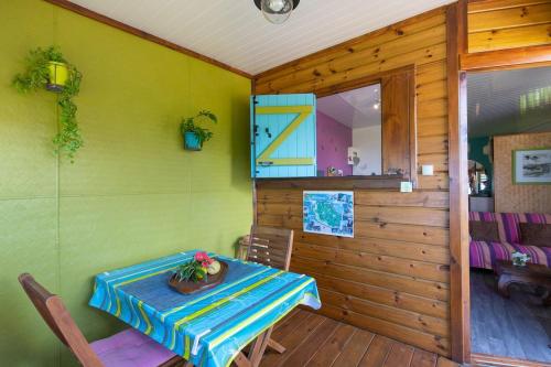 a dining room with a table and a room with at Bungalow Pointe Châteaux St Leu ocean view, pool in Saint-Leu