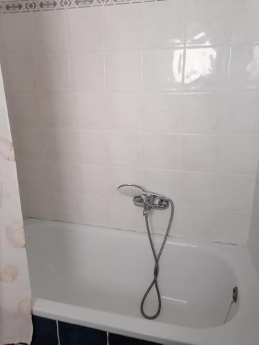 a shower head on a white wall in a bathroom at Kapsochora blue in Pefkohori