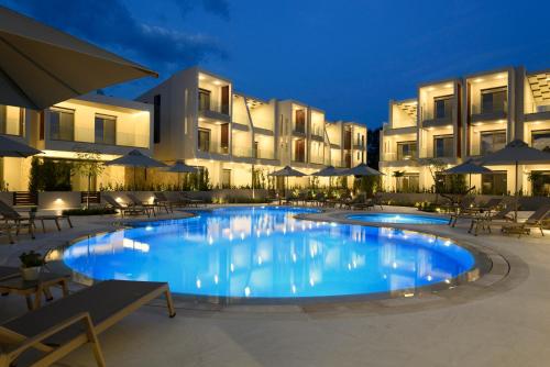 a large swimming pool in front of a hotel at DARION Residence in Nikiti