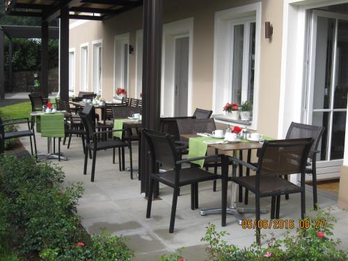 an outdoor dining area with tables and chairs on a patio at Villa zur Schmied'n in Ehrenhausen