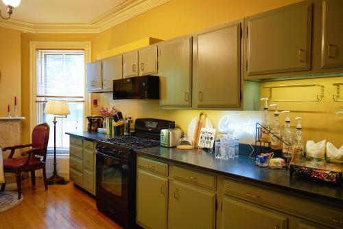 a kitchen with green cabinets and a black counter top at The Underwood-Hale House in Providence