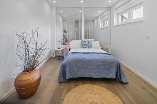 a bedroom with a bed and a vase on the floor at Luxurious VILLA LAPIS - heated pool, sauna, gym and spa, 120m to sandy beach in Omiš