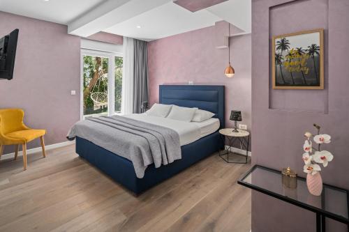 a bedroom with a bed and a table and a chair at Luxurious VILLA LAPIS - heated pool, sauna, gym and spa, 120m to sandy beach in Omiš