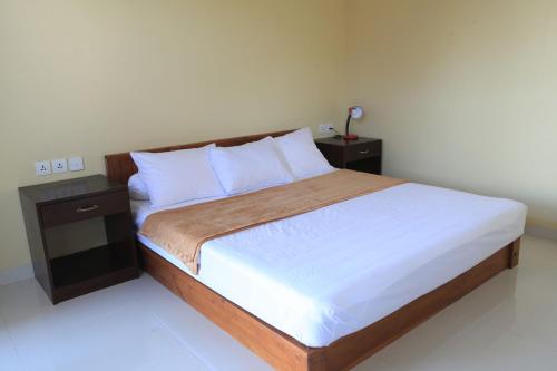 Кровать или кровати в номере Bukit Suites Villa
