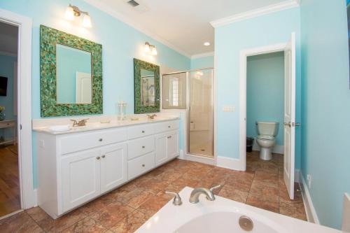 a bathroom with a tub and a sink and a toilet at 449 Tarpon Blvd in Fripp Island