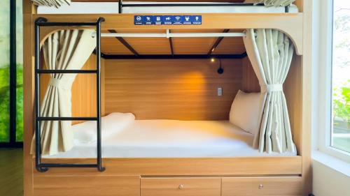 a bed in a room with a bunk bed at Hoi An Canal House Riverside By Haviland in Hoi An