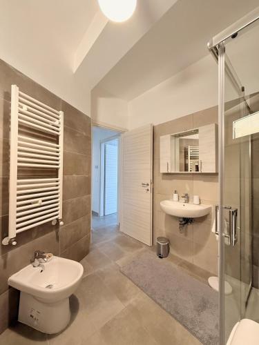 a bathroom with a sink and a toilet and a shower at Dimora Bella Vista in LʼAquila
