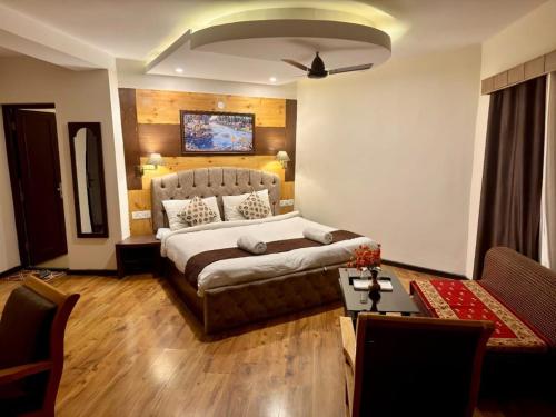 a bedroom with a bed and a couch in a room at The Nalanda Boho in Leh