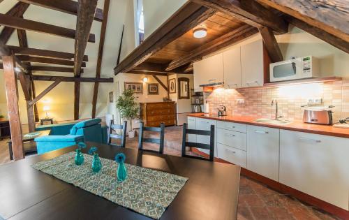 a kitchen and living room with a table and chairs at Latrán 43 apartments in Český Krumlov
