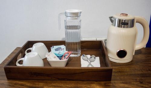 a wooden tray with a bottle of water and a blender at Three M Mirissa in Mirissa