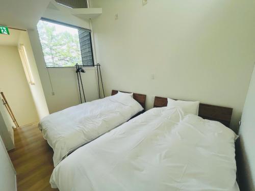 Katil atau katil-katil dalam bilik di Kinagashi Happo Chalet West