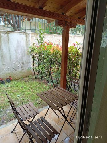 a patio with two chairs and a table and an umbrella at Kallithea Mare in Kallithea Halkidikis
