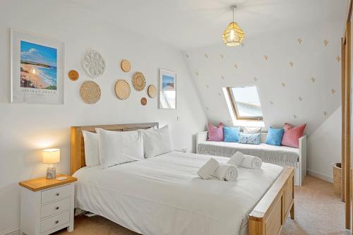 a bedroom with two beds and two windows at Pentire Point - Coastal Penthouse, Beaches, River & Restaurants All Within Short Walk in Newquay