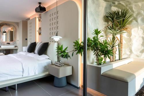 a bedroom with a bed and potted plants at 茑岛海景潮宿NiaoDao Seaview Hotel in Xiamen