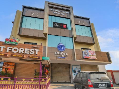 a building with a car parked in front of it at Hotel O Rj Royal Inn in Vellore