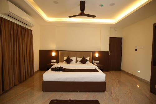 a bedroom with a bed and a ceiling fan at Jsm Residency Egmore in Chennai