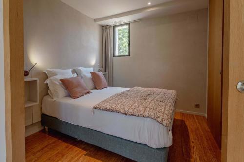 une chambre avec un lit avec des draps blancs et une fenêtre dans l'établissement Domaine de la Peyrine - Suite Tourterelle, à Carignan