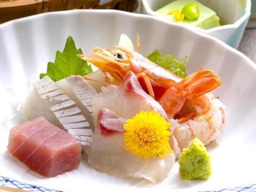 a white plate of food with meat and vegetables at Yukemuri no sato azumaya in Beppu