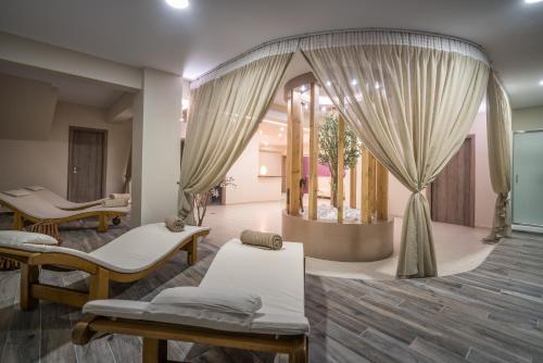 a therapy room with two beds and curtains at Park Hotel & Spa-Adults Only in Tsilivi