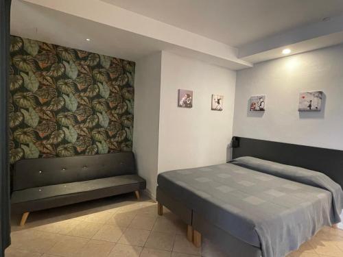 a bedroom with a bed and a wall with a wallpaper at San Valentino House in Bussolengo