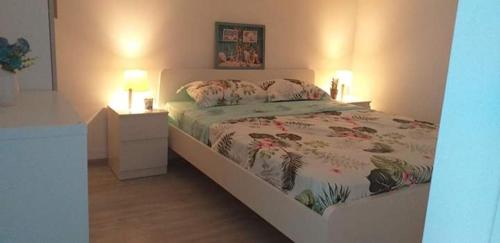 a bedroom with a bed and a nightstand with two lamps at Saturn Alfa Residence - 2 Rooms Apartment in Saturn