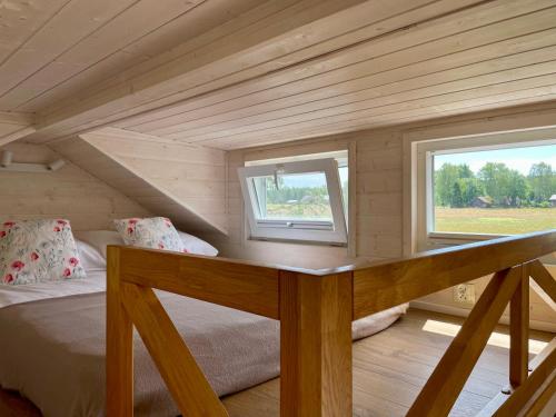 a small room with a bed and a window at Leśne Siedlisko Wygonin in Wygonin