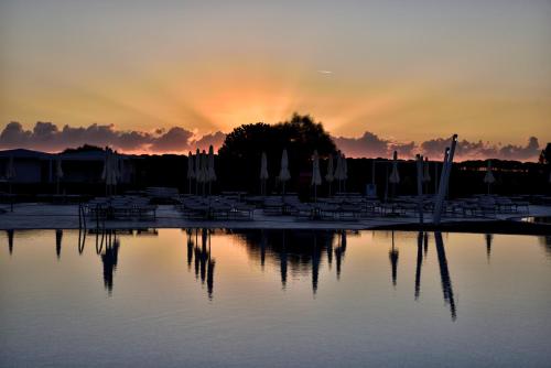 a group of boats in a marina at sunset at Janna e Luna Resort in Agrustos