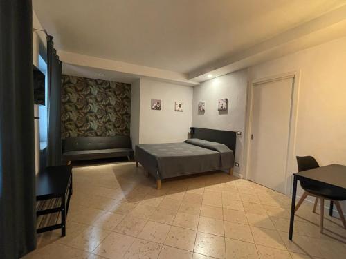a bedroom with a bed and a table and chairs at San Valentino House in Bussolengo