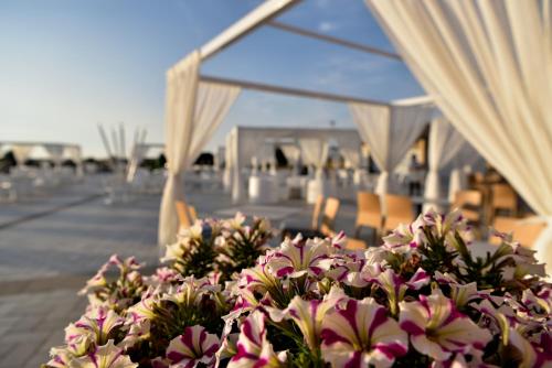 a bouquet of flowers sitting on a table under a marquee at Janna e Luna Resort in Agrustos