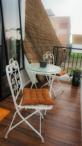 a table and two chairs on a balcony at Villa Kami Cijeruk in Cihideung