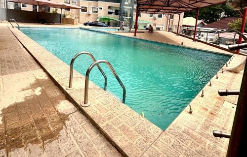 a large swimming pool with blue water in a building at Home in Abuja Municipal Area Council in Abuja