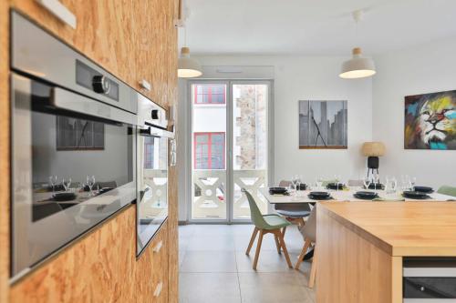 a kitchen with a table and a dining room at Villa au pied de la plage in Les Sables-dʼOlonne