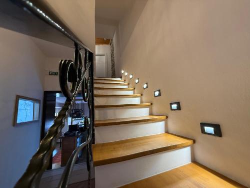 a winding staircase in a house with wooden floors at Submarine 105 Rooms in Gjirokastër