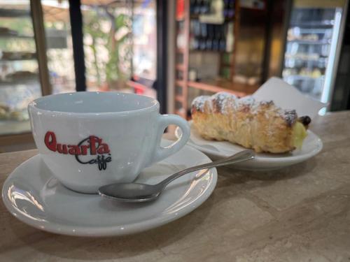 a cup of coffee and a piece of cake on a table at Bed&Dreams in Salento - Camera Matrimoniale Superior e ottima colazione in Guagnano
