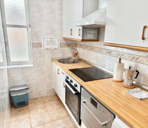 a kitchen with a sink and a counter top at Vive Zaragoza XV in Zaragoza