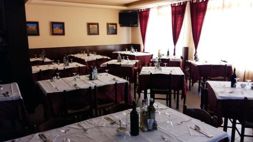 a dining room with tables and chairs with white table cloth at Alla Speranza in San Giórgio di Nogaro