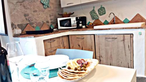 a kitchen with a table with a bowl of food on it at Nicola appartamento in Giba