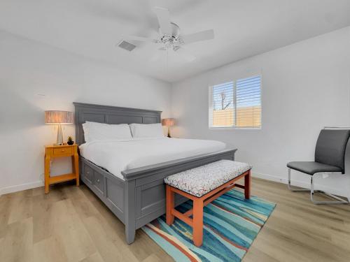 a bedroom with a bed and a chair and a window at Drew 251 Mesa in Mesa