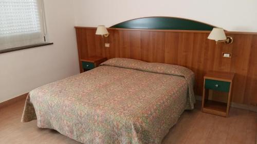 a hotel room with a bed and a mirror at Alla Speranza in San Giórgio di Nogaro