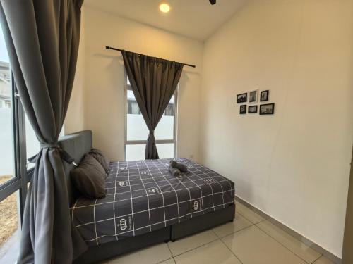 a bedroom with a bed in front of a window at Padang Serai Wangi Homestay 95 in Padang Serai