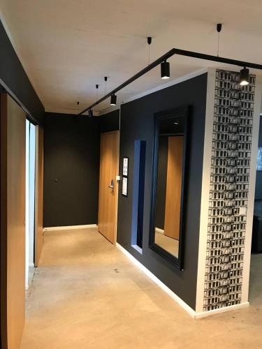 an empty room with a brick wall and a mirror at Stay Apartments Einholt in Reykjavík