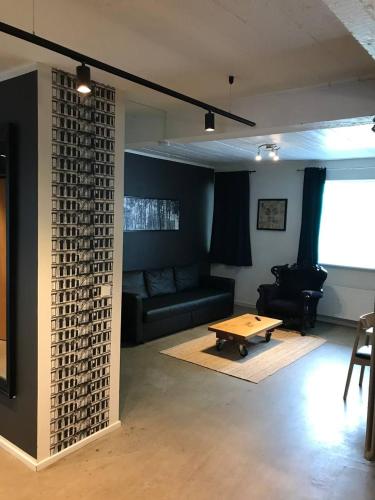 a living room with a couch and a coffee table at Stay Apartments Einholt in Reykjavík