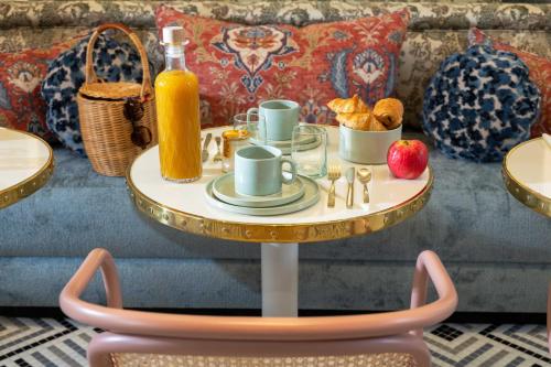 a table with a tray of food and a bottle of orange juice at Hôtel l'Inattendu in Paris