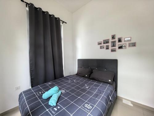 a bedroom with a bed with a blue object on it at Padang Serai Wangi Homestay 95 in Padang Serai