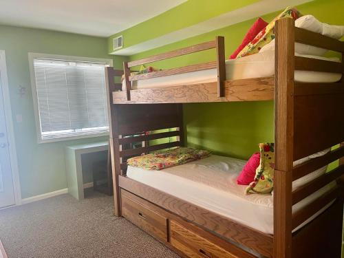 two bunk beds in a room with green walls at Wilmington avenue 50 #312 in Rehoboth Beach