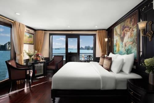 a bedroom with a large bed and a large window at Athena Royal Cruise - Luxury in Halong Bay in Ha Long