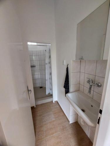 a bathroom with a tub and a sink and a mirror at Ubytování Vločka in Krnov